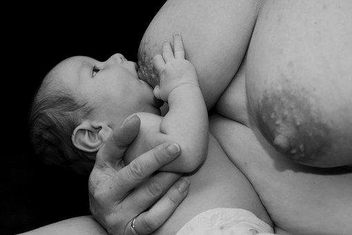 Baby breastfeeding black and white exposed breasts