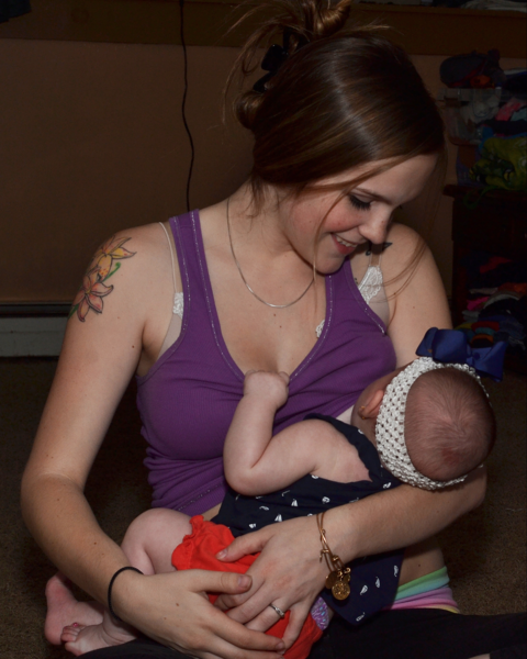 Mom with tattoo breastfeeding baby