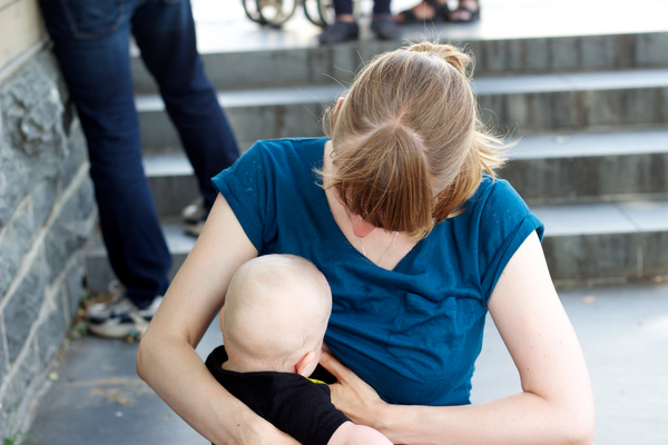 Mother breastfeeding baby in public