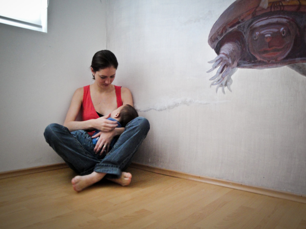 Mother breastfeeding baby yoga studio