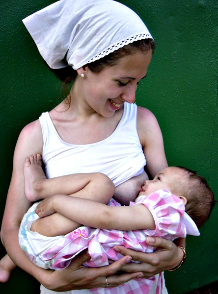 Mother smiling at baby brestfeeding
