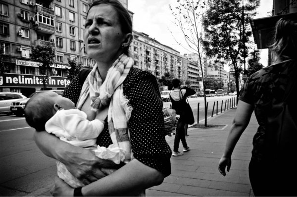 Mother walking while breastfeeding in Europe